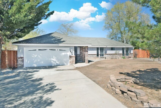 916 Tillman Ln, Gardnerville, NV 89460 - ranch-style home with fence, driveway, an attached garage, and a shingled roof