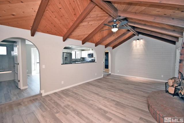 916 Tillman Ln, Gardnerville, NV 89460 - unfurnished living room with a ceiling fan, wood finished floors, wood ceiling, baseboards, and arched walkways