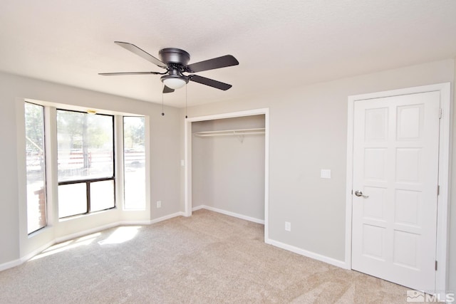 916 Tillman Ln, Gardnerville, NV 89460 - unfurnished bedroom featuring light colored carpet, baseboards, a closet, and a ceiling fan