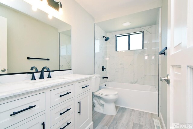 916 Tillman Ln, Gardnerville, NV 89460 - full bathroom with toilet, wood finished floors, vanity, and shower / tub combination
