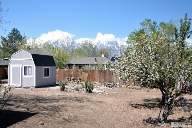 916 Tillman Ln, Gardnerville, NV 89460 - view of yard with fence, an outdoor structure, a mountain view, and a shed
