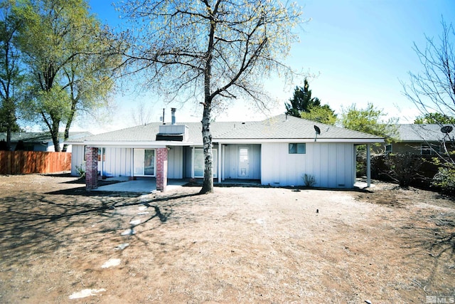 916 Tillman Ln, Gardnerville, NV 89460 - rear view of property featuring board and batten siding, fence, and a patio