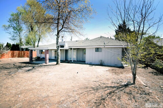 916 Tillman Ln, Gardnerville, NV 89460 - rear view of house with board and batten siding, fence, and roof with shingles