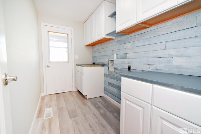 916 Tillman Ln, Gardnerville, NV 89460 - washroom featuring cabinet space, baseboards, light wood-style flooring, washer hookup, and wooden walls