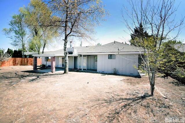 916 Tillman Ln, Gardnerville, NV 89460 - rear view of house with board and batten siding, fence, and roof with shingles