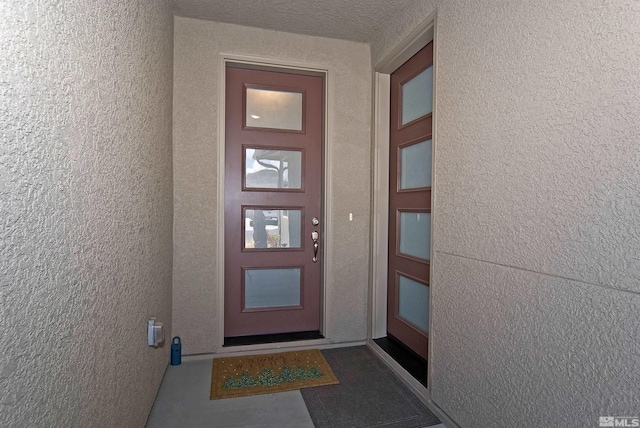 entrance to property featuring stucco siding