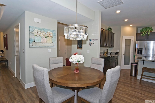 dining area with dark wood-type flooring, baseboards, a chandelier, and recessed lighting