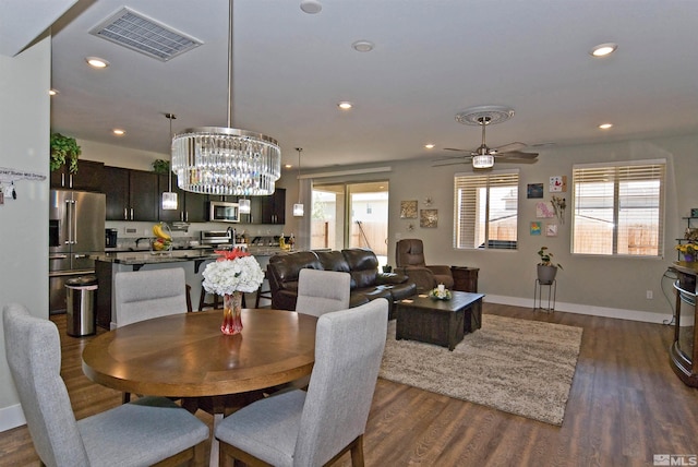 dining area with dark wood-style floors, a chandelier, recessed lighting, baseboards, and ceiling fan