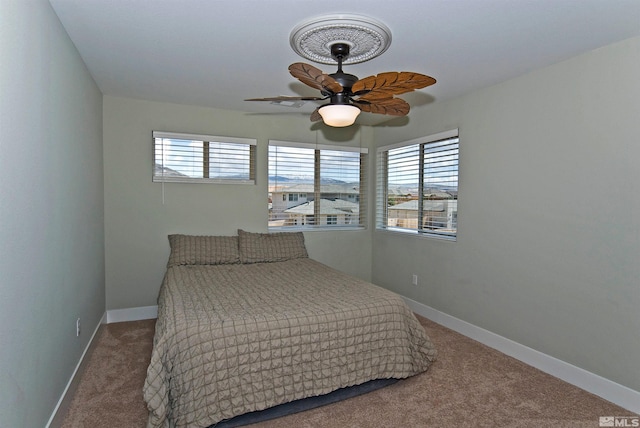 bedroom with carpet, baseboards, and a ceiling fan