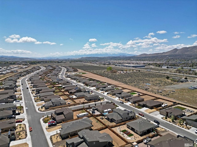 aerial view of residential area featuring mountains