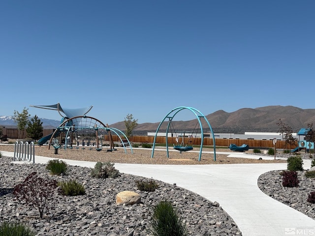 community playground with fence and a mountain view
