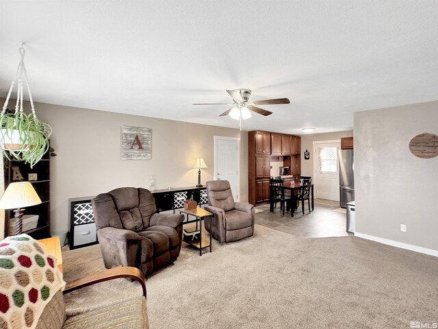 574 W National Ave, Winnemucca, NV 89445 - living area with a ceiling fan, light colored carpet, and baseboards
