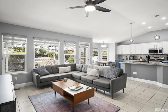 2445 Libero, Sparks, NV 89436 - living room featuring light tile patterned flooring, plenty of natural light, a ceiling fan, lofted ceiling, and baseboards