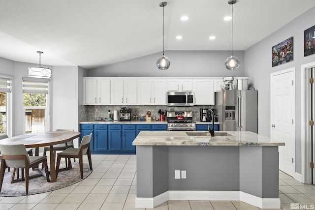 2445 Libero, Sparks, NV 89436 - kitchen with appliances with stainless steel finishes, blue cabinetry, a sink, tasteful backsplash, and decorative light fixtures