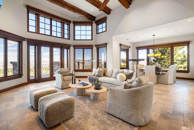 12360 High Vista Dr, Reno, NV 89511 - living room featuring stone tile flooring, a towering ceiling, baseboards, beam ceiling, and french doors