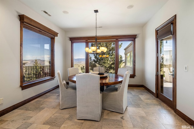 12360 High Vista Dr, Reno, NV 89511 - dining room with baseboards, stone tile floors, plenty of natural light, and a chandelier