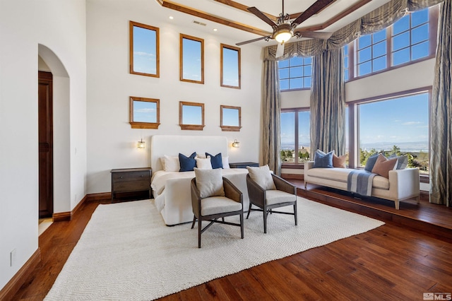 12360 High Vista Dr, Reno, NV 89511 - bedroom with arched walkways, a towering ceiling, dark wood-style floors, baseboards, and recessed lighting