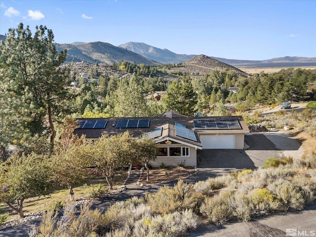 3750 Buckskin Rd, Carson City, NV 89703 - view of front of home with a mountain view, a garage, and solar panels