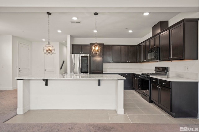 1987 Wind Ranch Rd Unit C, Reno, NV 89521 - kitchen featuring black appliances, a kitchen island with sink, a kitchen bar, a chandelier, and recessed lighting