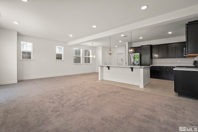 1987 Wind Ranch Rd Unit C, Reno, NV 89521 - kitchen with a kitchen breakfast bar, light colored carpet, recessed lighting, baseboards, and open floor plan