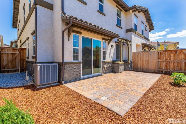 1987 Wind Ranch Rd Unit C, Reno, NV 89521 - back of property with cooling unit, fence, a patio area, and stucco siding