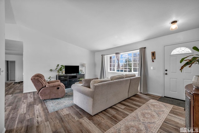10205 Shenandoah Dr, Reno, NV 89508 - living area featuring lofted ceiling, wood finished floors, and baseboards