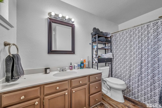 10205 Shenandoah Dr, Reno, NV 89508 - bathroom with toilet, wood finished floors, vanity, a textured ceiling, and curtained shower