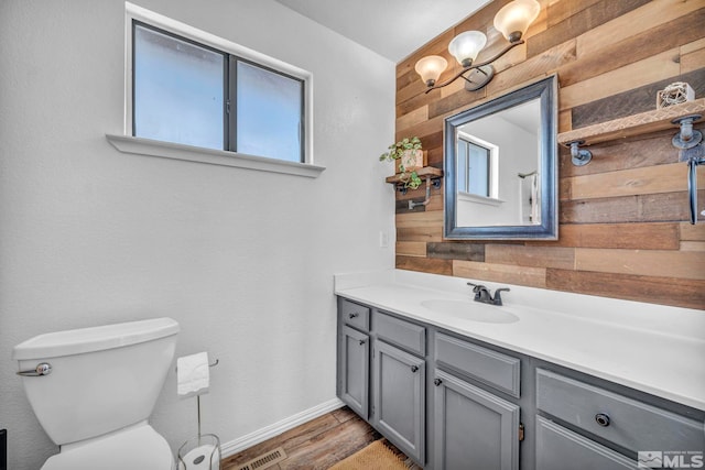 10205 Shenandoah Dr, Reno, NV 89508 - bathroom featuring wood walls, vanity, wood finished floors, toilet, and baseboards