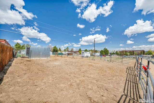 10205 Shenandoah Dr, Reno, NV 89508 - view of yard featuring an exterior structure, an outdoor structure, an enclosed riding area, and a view of countryside
