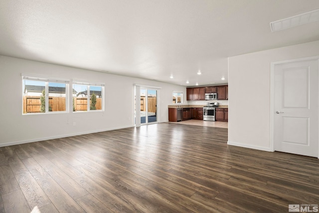 8971 Sagemoor Dr, Reno, NV 89506 - unfurnished living room featuring recessed lighting, dark wood-type flooring, and baseboards