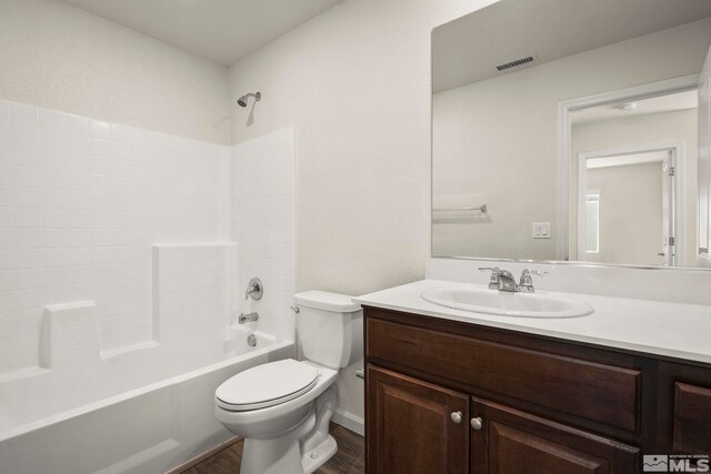 8971 Sagemoor Dr, Reno, NV 89506 - full bathroom featuring toilet, wood finished floors, vanity, and shower / bathtub combination