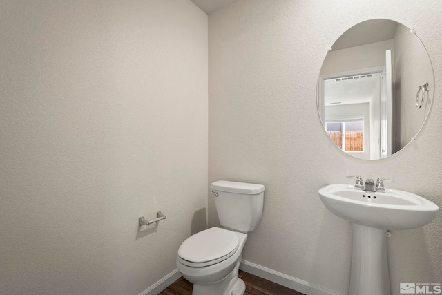 8971 Sagemoor Dr, Reno, NV 89506 - bathroom with toilet, wood finished floors, baseboards, and a sink