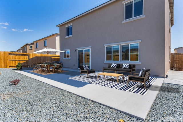 8971 Sagemoor Dr, Reno, NV 89506 - rear view of house featuring an outdoor living space, a fenced backyard, a patio area, and stucco siding