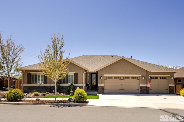 1058 Aspen Brook Ln, Gardnerville, NV 89460 - view of front of home featuring stone siding, an attached garage, stucco siding, concrete driveway, and fence