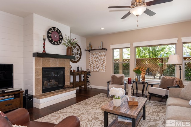1058 Aspen Brook Ln, Gardnerville, NV 89460 - living area featuring a tiled fireplace, wood finished floors, plenty of natural light, ceiling fan, and recessed lighting