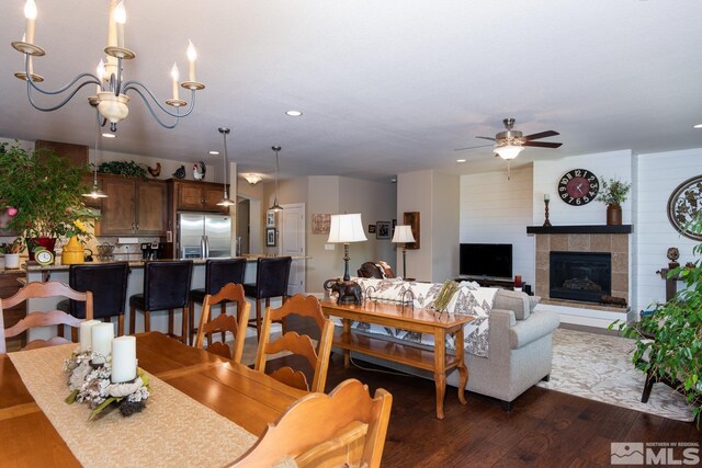 1058 Aspen Brook Ln, Gardnerville, NV 89460 - dining area featuring ceiling fan, dark wood-style flooring, recessed lighting, a chandelier, and a fireplace