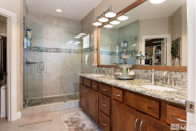 1058 Aspen Brook Ln, Gardnerville, NV 89460 - bathroom with a shower stall, a spacious closet, tile patterned floors, and double vanity