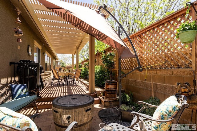 1058 Aspen Brook Ln, Gardnerville, NV 89460 - view of patio / terrace featuring an outdoor fire pit, outdoor dining space, and a pergola