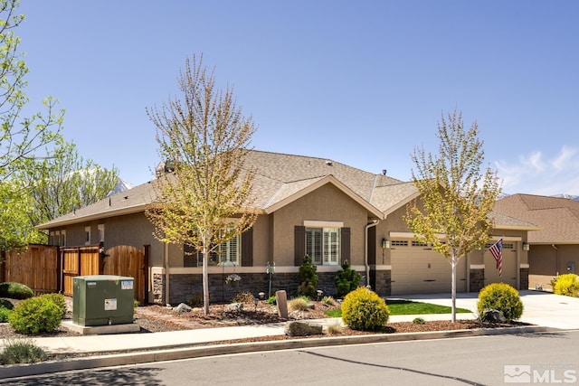 1058 Aspen Brook Ln, Gardnerville, NV 89460 - ranch-style home featuring stone siding, an attached garage, fence, driveway, and stucco siding