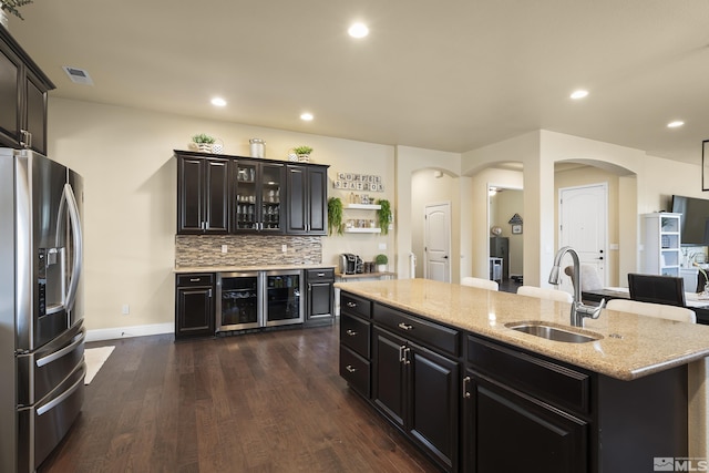540 Clove Hitch Ct, Sparks, NV 89441 - kitchen with stainless steel refrigerator with ice dispenser, a sink, dark wood-type flooring, arched walkways, and recessed lighting