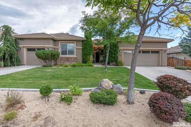 2705 Wind Feather Trl, Reno, NV 89511 - view of front of house with concrete driveway, stucco siding, an attached garage, and stone siding