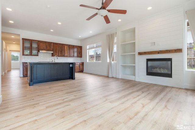 2705 Wind Feather Trl, Reno, NV 89511 - kitchen featuring baseboards, open floor plan, an island with sink, built in shelves, and recessed lighting