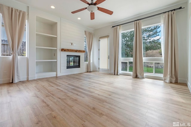 2705 Wind Feather Trl, Reno, NV 89511 - unfurnished living room featuring wood finished floors, baseboards, ceiling fan, recessed lighting, and a fireplace