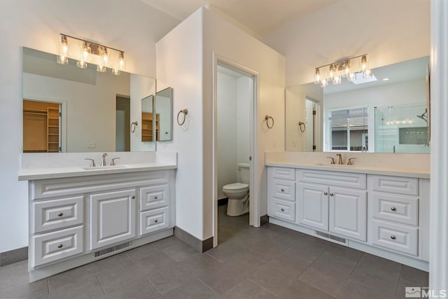 2705 Wind Feather Trl, Reno, NV 89511 - bathroom with two vanities, tile patterned floors, baseboards, and toilet
