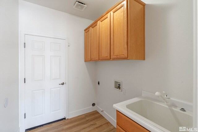 2705 Wind Feather Trl, Reno, NV 89511 - washroom featuring hookup for a washing machine, cabinet space, light wood-style floors, baseboards, and electric dryer hookup