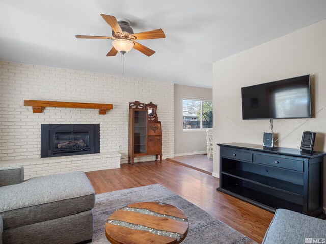 610 Akard Cir, Reno, NV 89503 - living room featuring wood finished floors, ceiling fan, a brick fireplace, and baseboards
