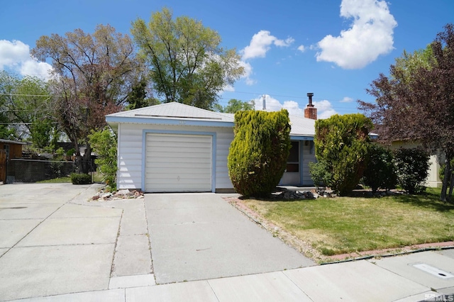 933 Cordone Ave, Reno, NV 89502 - view of front of house featuring a front yard, concrete driveway, a detached garage, and a chimney