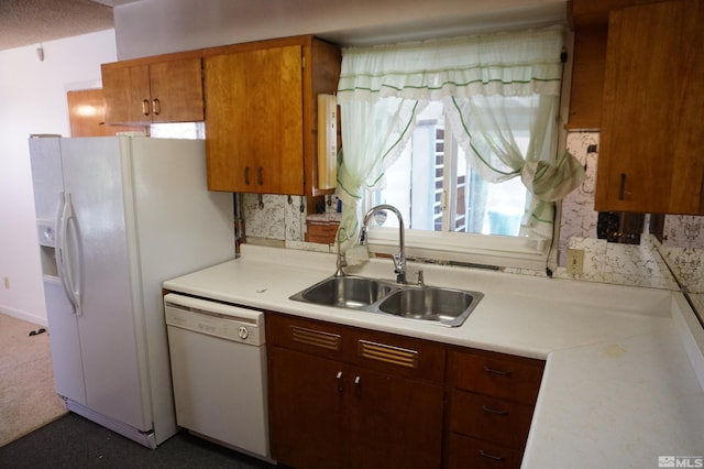 933 Cordone Ave, Reno, NV 89502 - kitchen with white appliances, a sink, light countertops, brown cabinets, and decorative backsplash