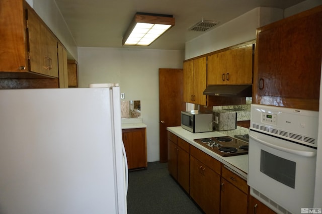 933 Cordone Ave, Reno, NV 89502 - kitchen with white appliances, light countertops, under cabinet range hood, and brown cabinets
