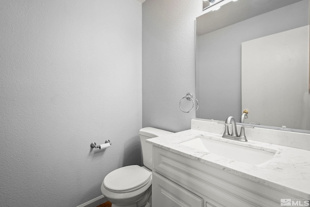 5645 Vista Luna Dr Apt 101, Sparks, NV 89436 - bathroom with a textured wall, toilet, and vanity